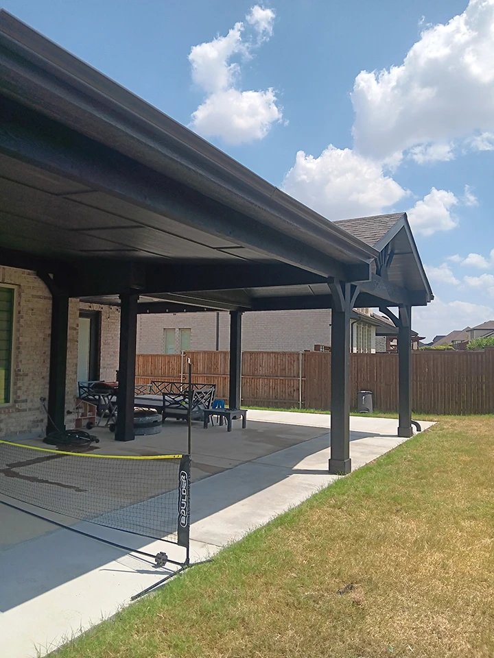 a brown patio cover in a house backyard